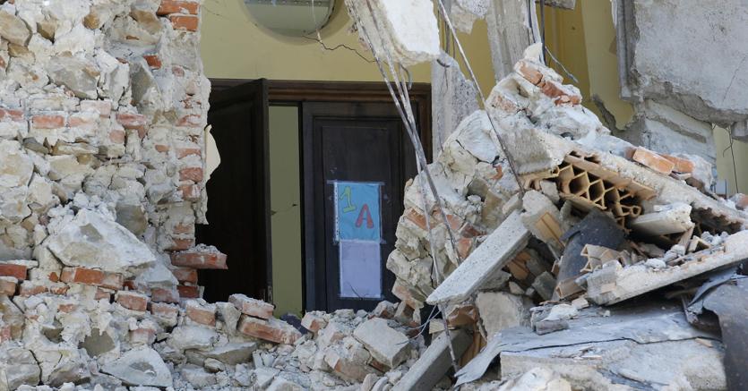 La porta di una classe tra le macerie della scuola, ristrutturata nel 2012, e crollata ad Amatrice in seguito al sisma del 24 agosto (AP Photo)