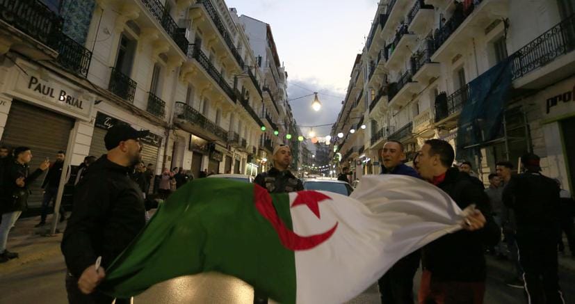 Cittadini algerini festeggiano in strada dopo il passo indietro di Bouteflika, che ha rinunciato a ricandidarsi (Reuters)