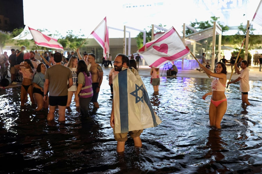 Un uomo si copre con una bandiera israeliana mentre la gente reagisce ai risultati degli exit poll durante le elezioni nazionali, a Tel Aviv, Israele, il 27 ottobre 2026. REUTERS/Nir Elias TPX IMMAGINI DEL GIORNO (REUTERS)