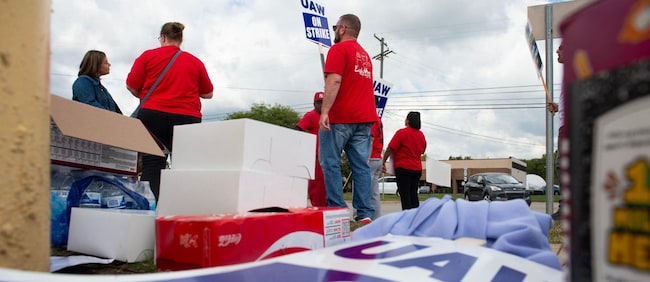 Members of the United Auto Workers (UAW) union walk the picket line in front of Ford Michigan Assembly Plant in Wayne, Michigan, on September 15, 2023. Workers at the "Big Three" US auto manufacturers went on strike on September 15, 2023, in a first-ever coordinated action to demand pay raises, testing the resilience of the US economy and threatening President Joe Biden's 2024 re-election momentum. A dramatic walkout -- observed outside a Detroit-area Ford plant with rowdy honking and cheers at the arrival of the United Auto Workers' leader -- followed a failed last-minute push by General Motors, Ford and Stellantis to produce an agreement before the deadline late on September 14, 2023. (Photo by Matthew Hatcher / AFP)