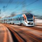 High speed train arrives on the railway station at sunset. Modern intercity train in motion on the railway platform. Passenger train on railroad with motion blur effect. Railway transportation