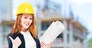 portrait of a successful architect with drawings on the construction site