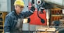 Turner worker working on drill bit in a workshop
