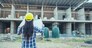 Woman construction engineer hold blueprint wear plaid shirt safety white hard hat at construction site industry labor worker. Architecture Female engineer civil worker look at blueprint real estate