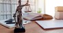 Lady Justice statue in law firm attorney office, blindfolded Justitia with balance scales and sword is personification of moral force in judicial system