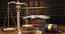 Justice concept. Gavel,  golden scales and books in the library with dof effect. 3d