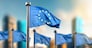 Waving flag of European Union on a blurred modern city backgroud and a few more flags in a row