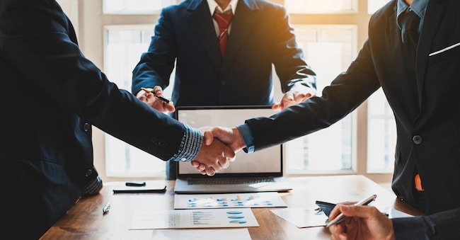Business people shake hands with business partnership at a meeting. The concept of mediation.