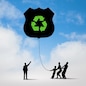 Silhouettes of people pulling balloon with recycle sign