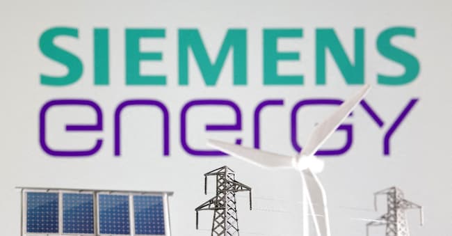 FILE PHOTO: Miniatures of windmill, solar panel and electric pole are seen in front of Siemens Energy logo in this illustration taken January 17, 2023. REUTERS/Dado Ruvic/File Photo