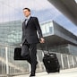 businessman walking with trolley and bag, business travel