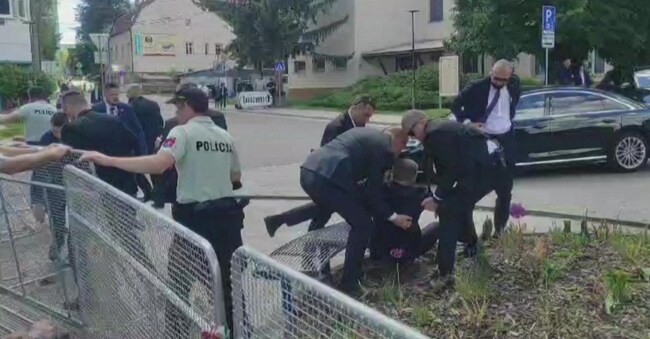 TOPSHOT - This image taken from video footage obtained by AFPTV shows security personnel carrying Slovakia's Prime Minister Robert Fico (C) towards a vehicle after he was shot in Handlova on May 15, 2024. Slovakia's Prime Minister Robert Fico was battling life-threatening wounds after officials said he was shot multiple times in an assassination attempt condemned by European leaders. (Photo by RTVS / AFP)