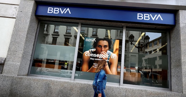 FILE PHOTO: A woman walks past a branch of Spain's BBVA bank in Bilbao, Spain, May 13, 2024. REUTERS/Vincent West/File Photo
