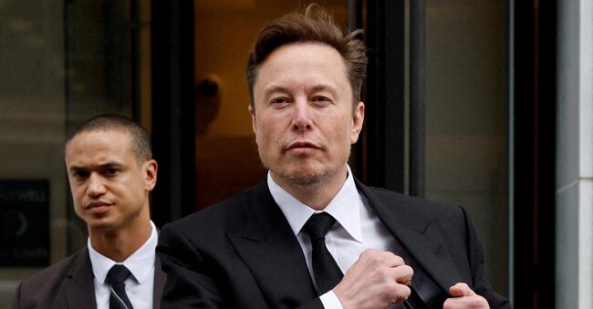 FILE PHOTO: Tesla CEO Elon Musk and his security detail depart the company?s local office in Washington, U.S. January 27, 2023.  REUTERS/Jonathan Ernst//File Photo