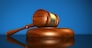 Law, justice and legal system concept with a wooden gavel judge symbol on blue background.