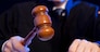 Judge. Male judge in a courtroom striking the gavel