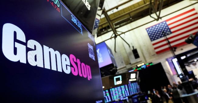 FILE PHOTO: A screen displays the logo and trading information for GameStop on the floor of the New York Stock Exchange (NYSE) in New York City, U.S., March 29, 2022.  REUTERS/Brendan McDermid/File Photo