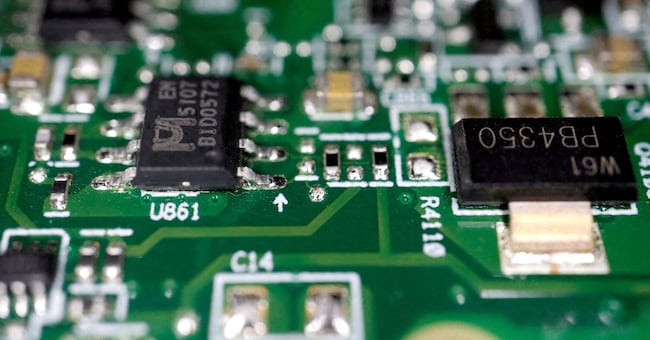FILE PHOTO: Semiconductor chips are seen on a printed circuit board in this illustration picture taken February 17, 2023. REUTERS/Florence Lo/Illustration//File Photo