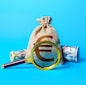 Euro money bag and magnifying glass. Investigating capital origins. Anti money laundering and tax evasion. Find investment funds for business project. Profitable deposit or loan terms and conditions.