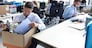 Sad dismissed worker are taking his office supplies with him from office.