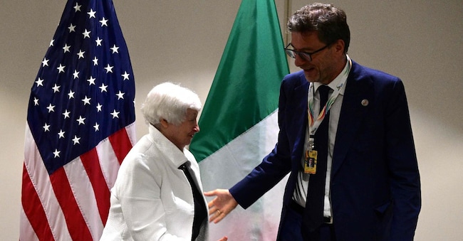 US Treasury Secretary Janet Yellen (L) shakes hands with Italy's Minister of Economy and Finance Giancarlo Giorgetti before a bilateral meeting in the framework of the G20 Ministerial Meeting in Rio de Janeiro, Brazil, on July 25, 2024. G20 finance chiefs meeting in Rio de Janeiro diverged over the idea of a coordinated wealth tax, promoted by Brazil but opposed by the United States, that advocates that each country should adopt its own "fair and progressive" tax system. (Photo by Pablo PORCIUNCULA / AFP)