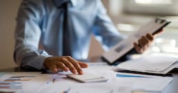 Business accounting concept, Business man using calculator with computer laptop, budget and loan paper in office.