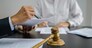 Legal counsel presents to the client a signed contract with gavel and legal law. justice and lawyer concept.