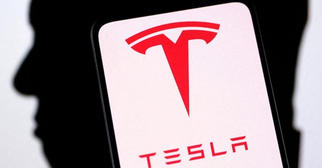 Tesla logo and Elon Musk silhouette are seen in this illustration taken, December 19, 2022. REUTERS/Dado Ruvic/Illustration/File Photo