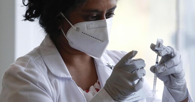 epa10104698 Healthcare worker Sapana Patel prepares a syringe with a dose of the Monkeypox vaccine, at a vaccination clinic at the West Hollywood Library, in West Hollywood, California, USA, 03 August 2022. Pop-up vaccination clinics have emerged across Los Angeles County, making vaccinations availble only for specific risk groups while supplies are limited. EPA/CAROLINE BREHMAN