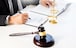 lawyer judge reading and writes the document in court at his desk.