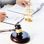 lawyer judge reading and writes the document in court at his desk.