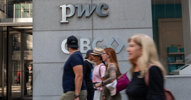 NEW YORK, NEW YORK - SEPTEMBER 12: People walk by PricewaterhouseCoopers (PwC) New York headquarters after the company announced a major restructuring on September 12, 2024 in New York City. PwC LLP will let go of up to 1,800 US employees next month as the accounting firm shifts to in-house technology developers and streamlines its advisory practice.   Spencer Platt/Getty Images/AFP (Photo by SPENCER PLATT / GETTY IMAGES NORTH AMERICA / Getty Images via AFP)