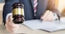Male Judge In A Courtroom Striking The Gavel on sounding block.