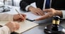 Lawyer colleagues or legal team working or drafting legal document at law firm office desk. Gavel hammer for righteous and equality judgment by lawmaker and attorney. Equilibrium