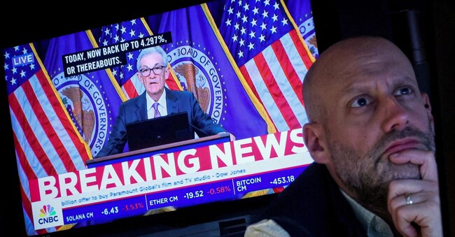 FILE PHOTO: A trader works, as a screen broadcasts a news conference by U.S. Federal Reserve Chair Jerome Powell following the Fed rate announcement, on the floor of the New York Stock Exchange (NYSE) in New York City, U.S., March 20, 2024.  REUTERS/Brendan McDermid/File Photo