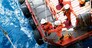 Offshore oil and gas platform during crew boat transfer worker to the platform during sunset time