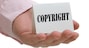Holding copyright sign on hand