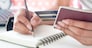 Hand holding passport and credit card. Travel, insurance or e-payment concept