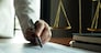 Lawyer working with contract papers on the table in office. consultant lawyer, attorney, court judge, concept.
