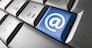 Web and Internet contact us concept with at icon and symbol on a laptop computer key for blog and on line business.