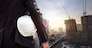White helmet of engineer architect holding by businessman in suit and building construction site background