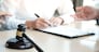 Legal counsel presents to the client a signed contract with gavel and legal law. justice and lawyer concept