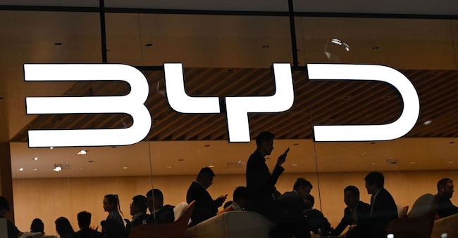 (FILES) The BYD logo is displayed at the Beijing Auto Show on April 25, 2024. Chinese electric vehicle giant BYD reported surging sales on October 30, 2024, surpassing global rival Tesla in quarterly revenue for the first time ever as its push into overseas markets advances. (Photo by PEDRO PARDO / AFP)