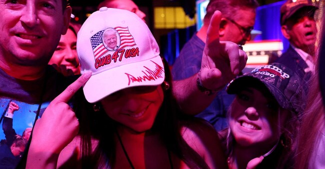WEST PALM BEACH, FLORIDA - NOVEMBER 05: Supporters pose for a photo during an election night watch party for Republican presidential nominee, former U.S. President Donald Trump at the Palm Beach Convention Center on November 05, 2024 in West Palm Beach, Florida. Americans cast their ballots today in the presidential race between Republican nominee former President Donald Trump and Vice President Kamala Harris, as well as multiple state elections that will determine the balance of power in Congress.   John Moore/Getty Images/AFP (Photo by JOHN MOORE / GETTY IMAGES NORTH AMERICA / Getty Images via AFP)