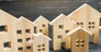 City of wooden figurines of houses. Buying and selling real estate. Renovation and home improvement. Mortgage loan. Building maintenance. Renting housing, realtor services.