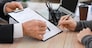 Man signing documents at notary public office