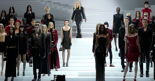 Donatella Versace, top center, acknowledges the audience at the end of the Versace women's Fall-Winter 2024-25 collection presented in Milan, Italy, Friday, Feb. 23, 2024. (AP Photo/Antonio Calanni)