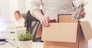 Nothing left behind. Attentive dedicated fired man packing his stuff in a box as he cleaning his workplace before leaving the office
