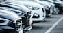 Show a close-up of the front grilles and headlights of cars lined up in the dealer parking lot, highlighting the sleek designs and modern features. white scene. stock photo --ar 16:9 --style raw Job ID: 5818d07f-2882-4fff-a469-68de0cc2dbb8