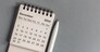 Monthly desk calendar for December 2024 on a gray background.